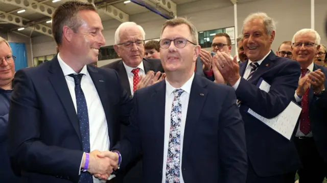 Sir Jeffrey Donaldson shakes hands with Paul Givan after topping the first preference votes in Lagan Valley