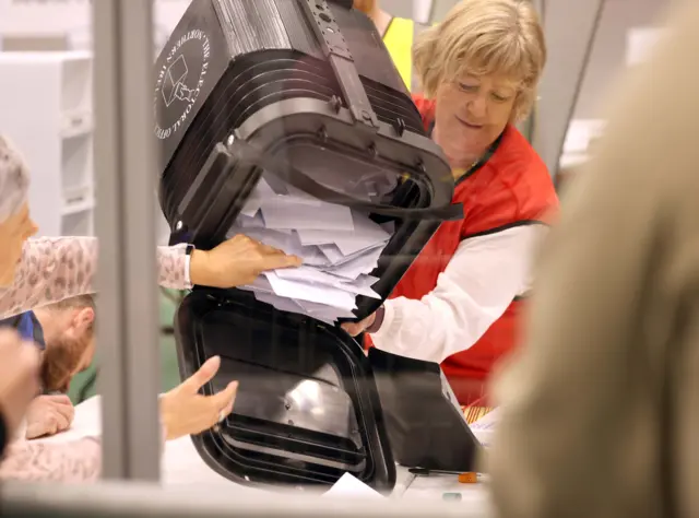 Woman emptying ballot box