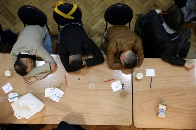 Members of staff take a rest during Westminster's local election count