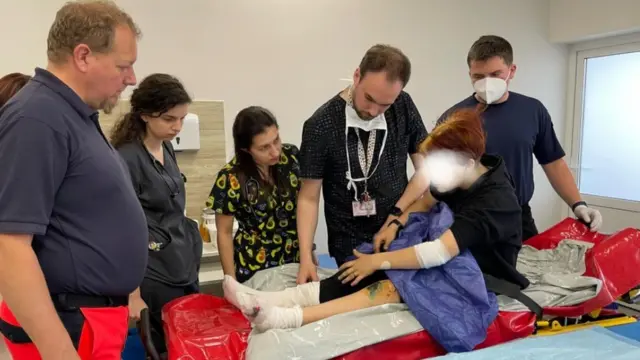 Lisa shows doctors in Lviv her wounds after the shelling