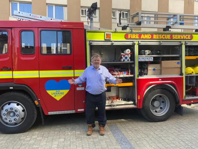 Daniel Hannan pictured with a fire truck in Lviv