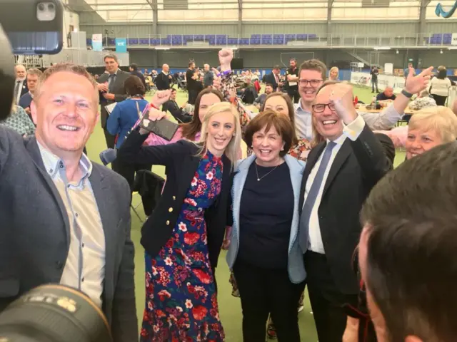 Diane Dodds posing with DUP MP Clara Lockhart and her husband Nigel Dodds