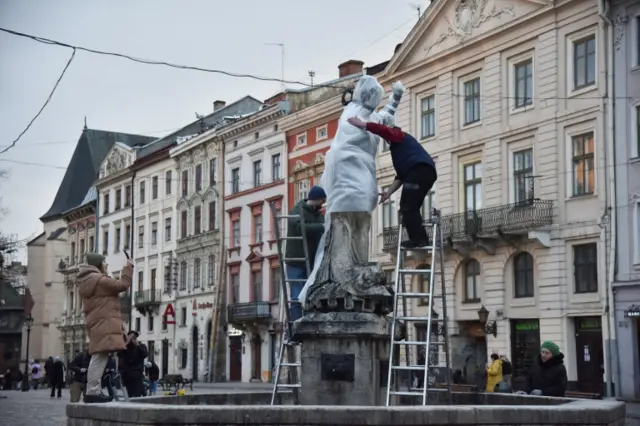 A statue in Lviv is wrapped in protective fabric, on 3 March 2022