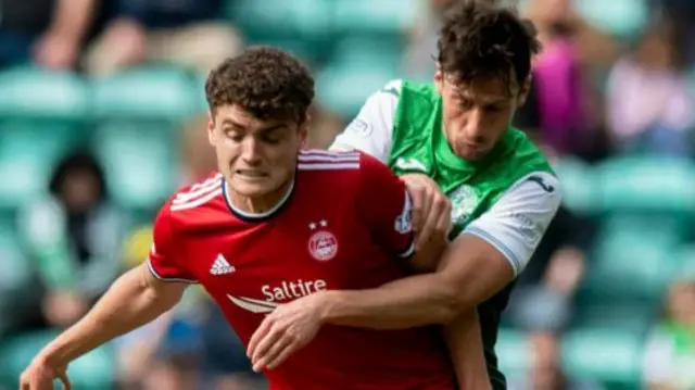 Aberdeen's Dante Polvara holds off Hibs' Joe Newell