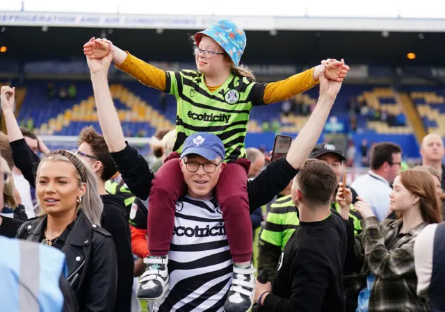 Forest Green Rovers fans celebrating winning the league after the final whistle