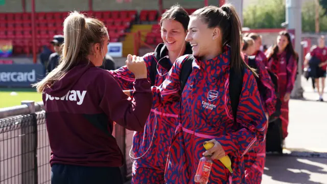 Lisa Evans greets Steph Catley and Lotte Wubben-Moy