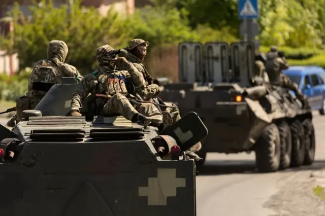 Ukrainian soldiers ride on an armored vehicle enroute to the front line, amid Russia"s invasion in Ukraine, in Bakhmut in the Donetsk region, Ukraine, May 8, 2022.