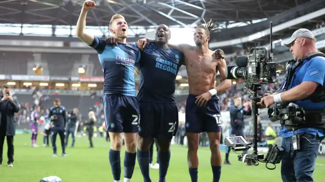 Adebayo Akinfenwa of Wycombe Wanderers celebrates with team-mates