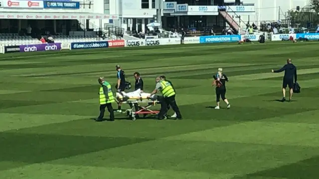 Robbie White stretchered off.