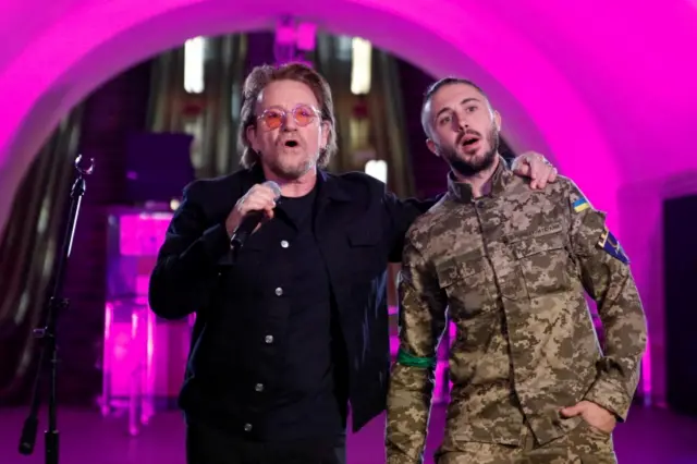 U2 rock band frontman Bono and Ukrainian serviceman, frontman of the Antytila band Taras Topolia sing during a performance for Ukrainian people inside a subway station, as Russia"s attack on Ukraine continues, in Kyiv, Ukraine May 8