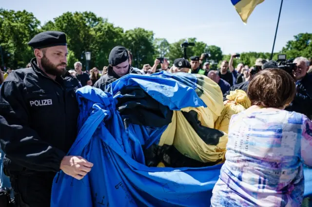 Police in Berlin, Germany, roll up Ukrainian flag at VE event