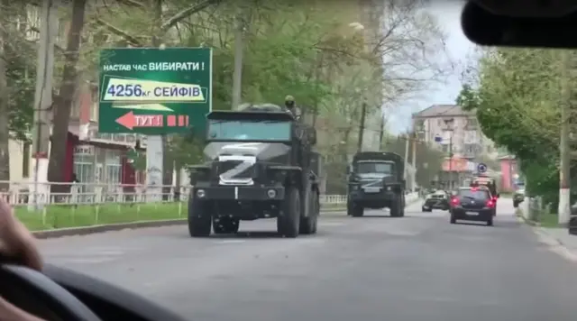 Russian vehicles marked with the letter Z drive through Kherson