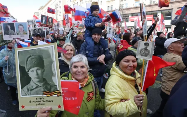 People hold portraits of their relatives who fought World War II, during an Immortal Regiment memorial in Moscow