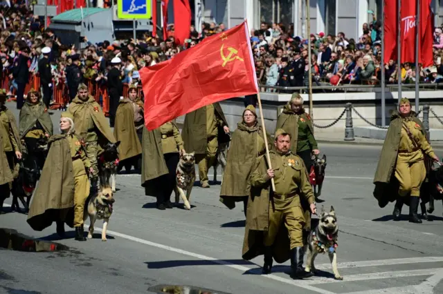 Participants wearing historical uniforms take part in a military parade in Vladivostok