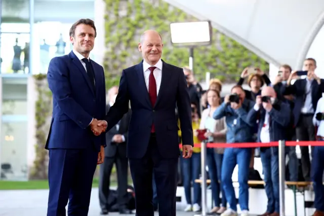 Germany's Chancellor Olaf Scholz welcomes France's President Emmanuel Macron with military honours during a ceremony at the Chancellery in Berlin, Germany, on 9 May 2022