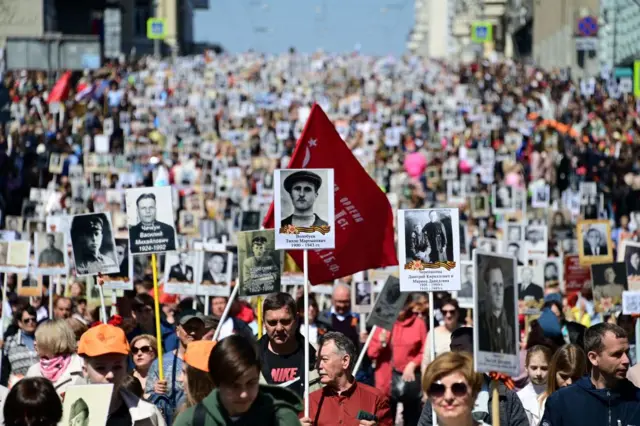 People carry portraits of their relatives - WWII soldiers - as they take part in the Vladivostok march