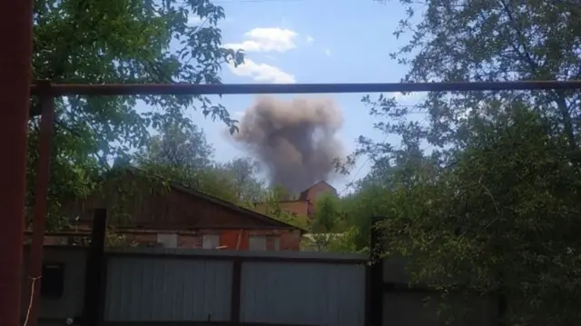 Explosion in the sky behind a residential fence