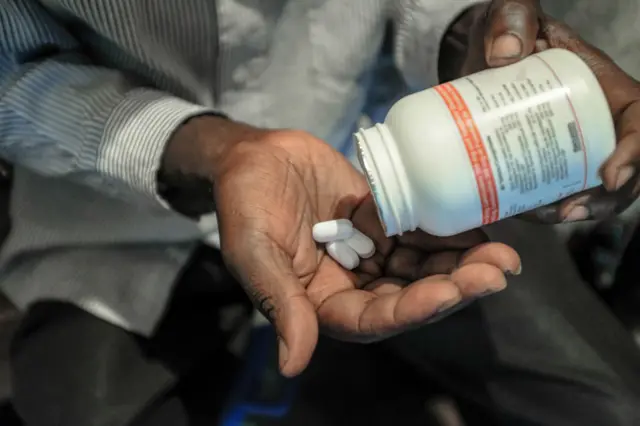 A man takes his Antiretroviral drugs