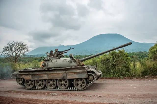 A Congolese army tank heads towards the front line near Kibumba in the area surrounding the North Kivu city of Goma on May 25, 2022 during clashes between the Congolese army and M23 rebels