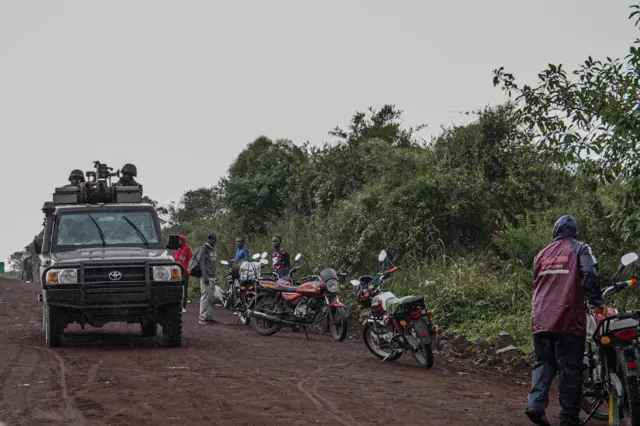 (Armed Forces of the Democratic Republic of Congo) soldiers ask people on their way to Kibumba to return to their homes, following clashes with M23 rebels in the region,