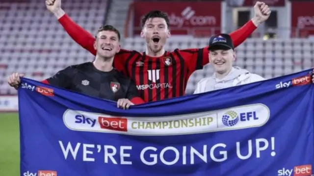 Kieffer Moore celebrating with Wales teammates Chris Mepham and David Brooks