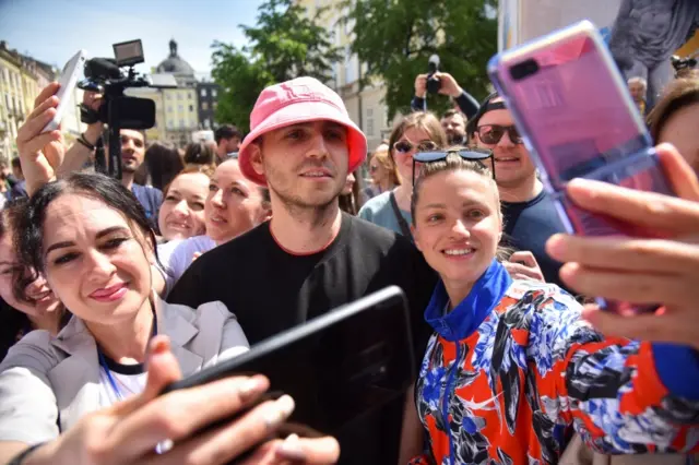 Oleh Psiuk, frontman of the 2022 Eurovision Song Contest winners Kalush Orchestra, takes a selfie with fans in Lviv, on 17 May