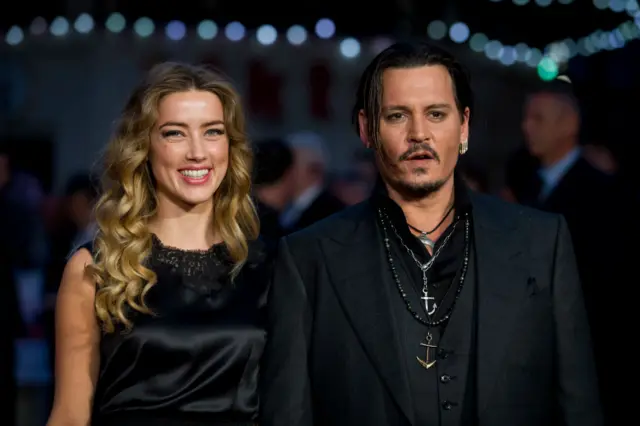 Actors Amber Heard and Johnny Depp pose for photos in 2015