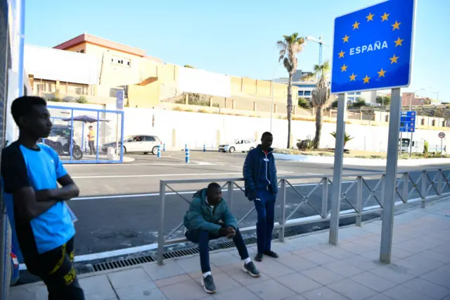 People cross the border of Morocco and Spain at the Ceuta border