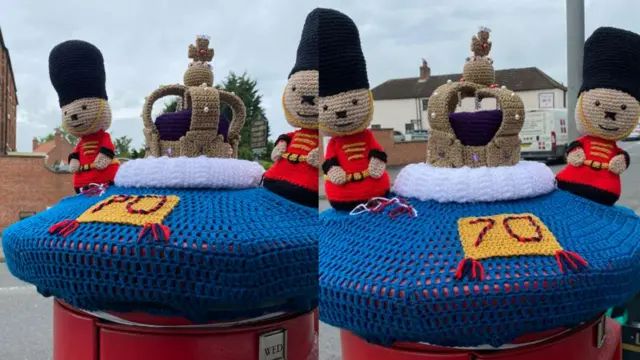 Knitted soldiers on top of a post box