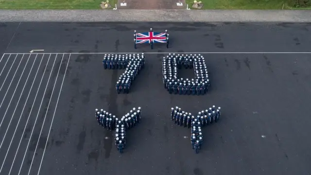 Trainee sailors forming a 70 and two large propellers