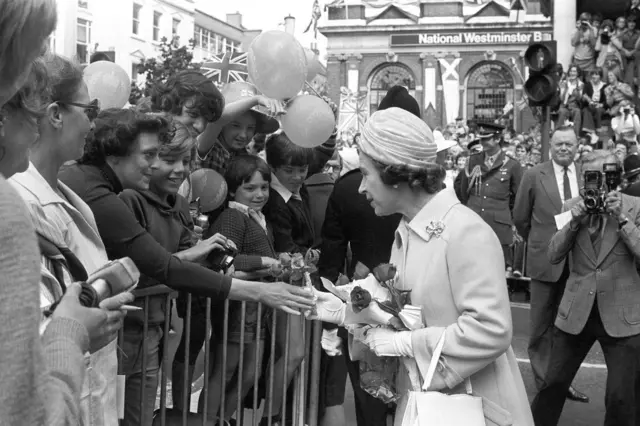 The Queen receives a rose from an onlooker, during a walkabout among the crowds in Ipswich, during her Silver Jubilee Tour of Britain on 11 July 1977