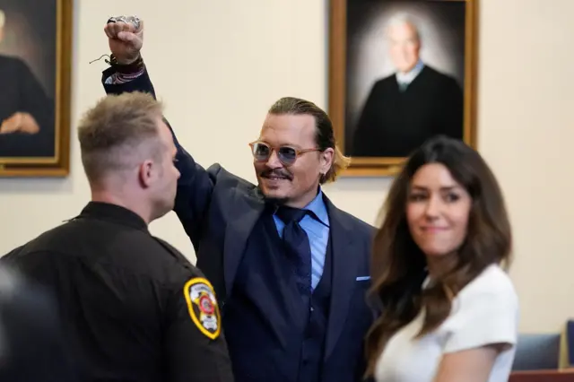 Johnny Depp gestures to court spectators