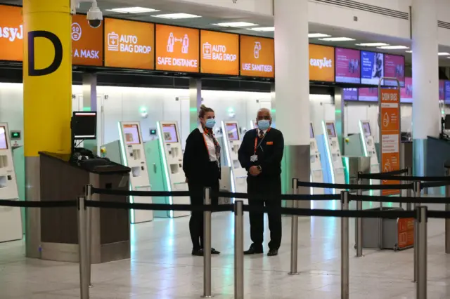 Easy Jet workers at Gatwick Airport on March 27, 2022 in London, England. Gatwick's South terminal closed in June 2020 to reduce costs during the Coronvirus pandemic when traveller numbers reduced significantly