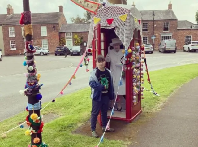 Life-size cut out of Queen Elizabeth in a phone box