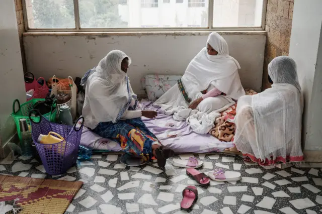 A 35-year-old woman (C) stays with her family's help at the corner of the floor due to the lack of beds at Ayder Referral