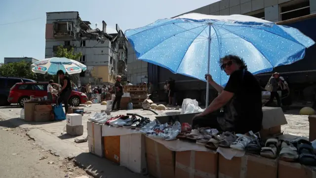 A street vendor sells footwear during Ukraine-Russia conflict in the southern port city of Mariupol, Ukraine May 30, 2022.