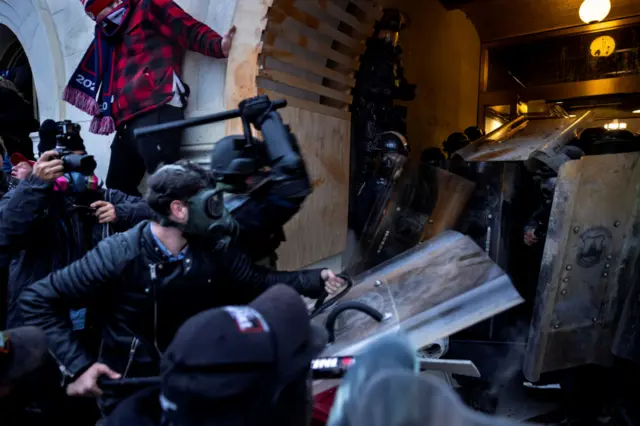 January 6 rioters breaking in to the US Capitol.