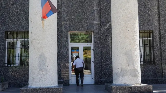 A person enters the Supreme Court building of the self-proclaimed Donetsk People"s Republic (DPR) in Donetsk, eastern Ukraine, 10 June 2022. On 09 June 2022, DPR"s Supreme Court sentenced two British nationals and a Moroccan national to death. The three men, who fought for the Ukrainian Armed Forces and then surrendered, were accused by local authorities of participating in hostilities on the side of Ukraine as mercenaries. On 24 February Russian troops had entered Ukrainian territory in what the Russian president declared a "special military operation", resulting in fighting and destruction in the country and a humanitarian crisis. EPA/ALESSANDRO GUERRA