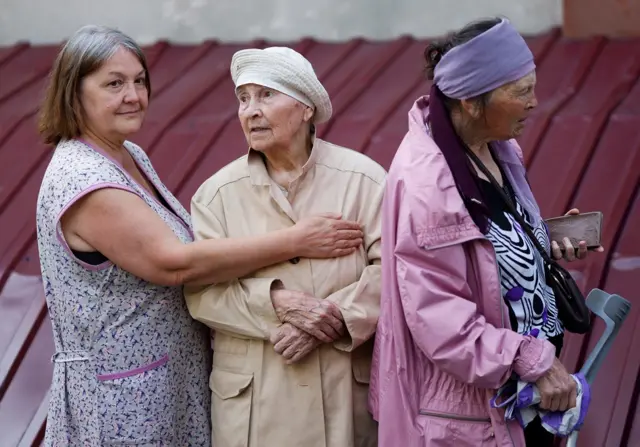 Residents stand in line to collect humanitarian aid at a Red Cross distribution point, as Russia"s attacks on Ukraine continues, in Mykolaiv, Ukraine June 10, 2022.