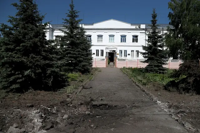 A crater is seen in front of a school following a military strike, amid Russia"s attack on Ukraine, on the outskirts of Kharkiv, Ukraine June 10, 2022. REUTERS/Ivan Alvarado