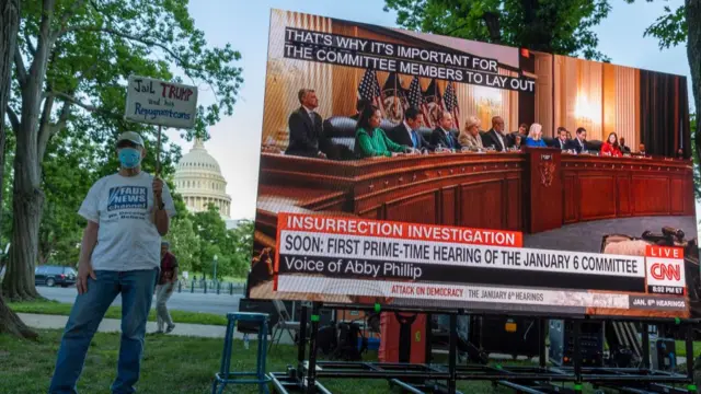 People watch the hearing from a Washington DC park