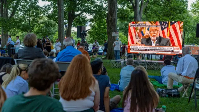 People watch the hearing from a Washington DC park