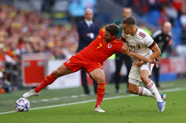 Joe Allen of Wales is challenged by Leandro Trossard