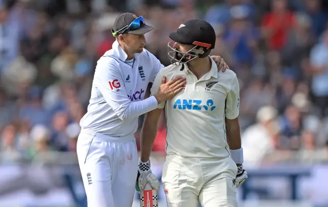 Joe Root pats Daryl Mitchell on the back after his 190