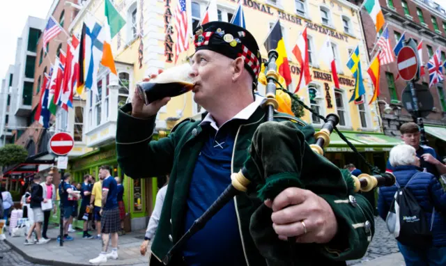 A Scotland fan drinks a pint of Guinness before Scotland's game with Ireland in Dublin