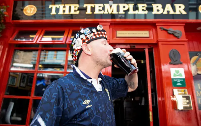 Ryan Sutherland from the Shetland islands drinks a Guiness outside the Temple Bar before the UEFA Nations League match between Ireland and Scotland at the Aviva Stadium