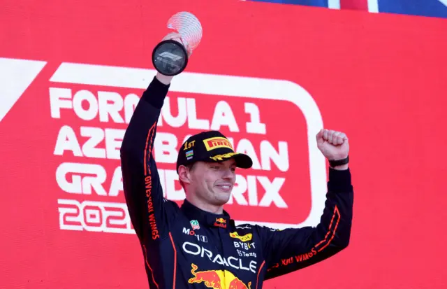 Max Verstappen lifts the trophy after winning in Baku