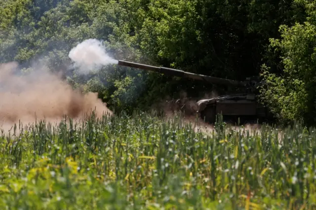 Ukrainian servicemen fire towards Russian troops with a tank at a position in the Donetsk region.