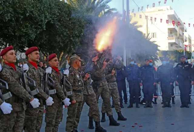 Tunisian soldiers fire a ceremonial gun salute to mark the 11th anniversary of the start of the 2011 revolution,