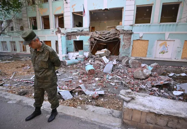A representative of the self-proclaimed Donetsk People's Republic, Eduard Basurin, in front of the school number 22, which was shelled on April 30 in Donetsk
